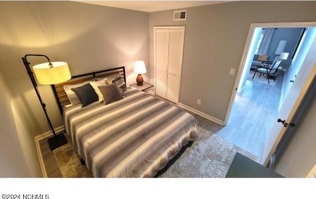 10166 Beach Dr SW Unit 5306, Calabash, NC 28467 - bedroom with wood finished floors and baseboards