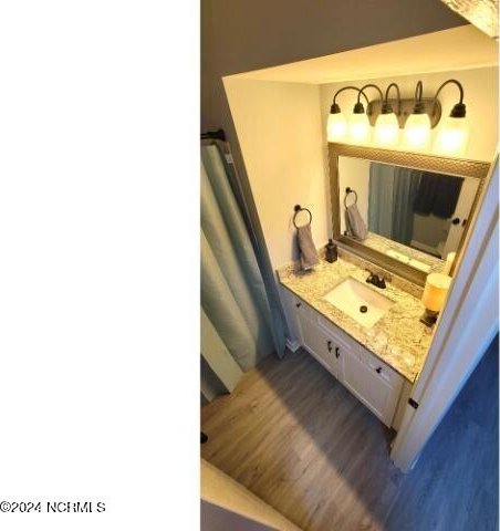 10166 Beach Dr SW Unit 5306, Calabash, NC 28467 - bathroom featuring wood finished floors and vanity