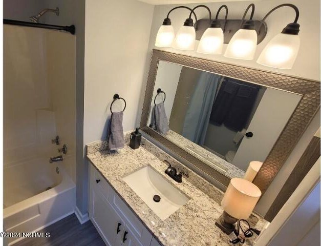 10166 Beach Dr SW Unit 5306, Calabash, NC 28467 - bathroom with vanity, shower / washtub combination, and wood finished floors