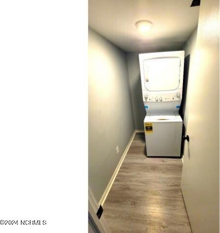 10166 Beach Dr SW Unit 5306, Calabash, NC 28467 - laundry room with stacked washing machine and dryer and light wood finished floors