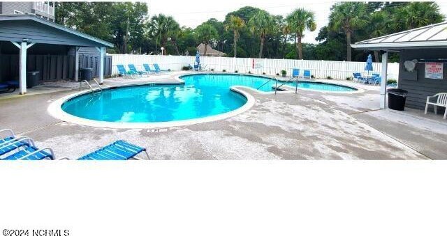 10166 Beach Dr SW Unit 5306, Calabash, NC 28467 - community pool with a patio and view of wooded area