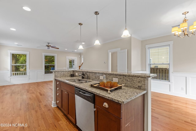 kitchen with dishwasher, sink, light stone countertops, light hardwood / wood-style flooring, and decorative light fixtures