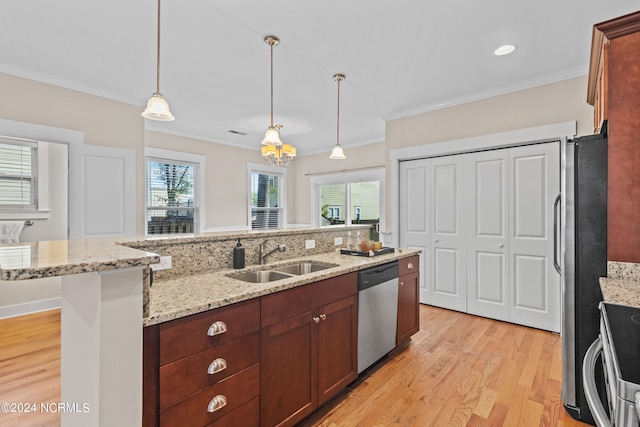 kitchen featuring stainless steel appliances, light hardwood / wood-style floors, sink, hanging light fixtures, and crown molding