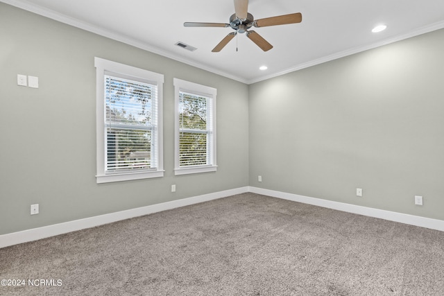 carpeted spare room featuring ceiling fan and ornamental molding