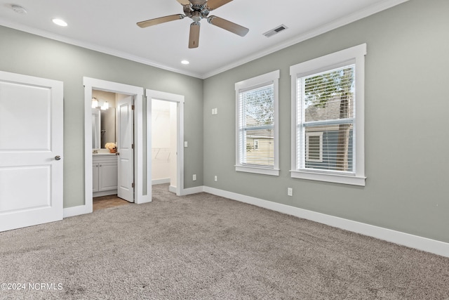 unfurnished bedroom with a spacious closet, light carpet, and ceiling fan