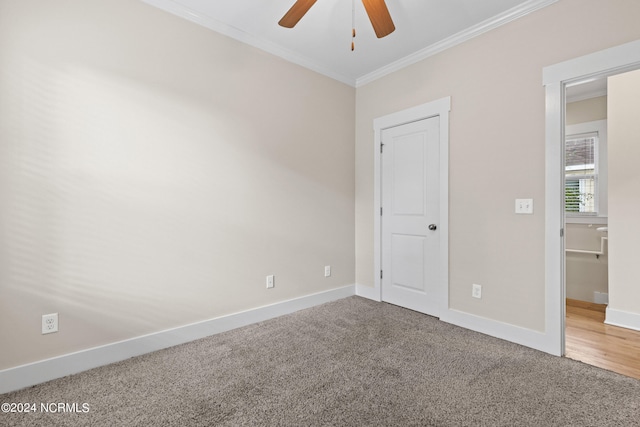 unfurnished bedroom featuring ornamental molding, ceiling fan, and carpet floors