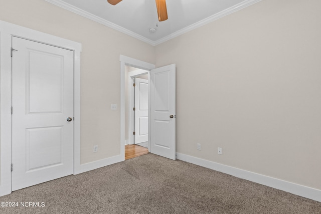 unfurnished bedroom featuring carpet, ceiling fan, and crown molding