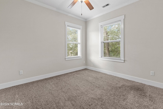 carpeted spare room with ceiling fan and crown molding