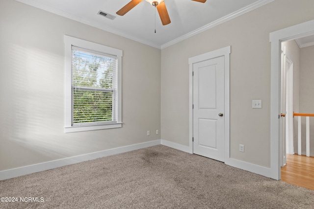 unfurnished bedroom featuring ornamental molding, carpet flooring, and ceiling fan