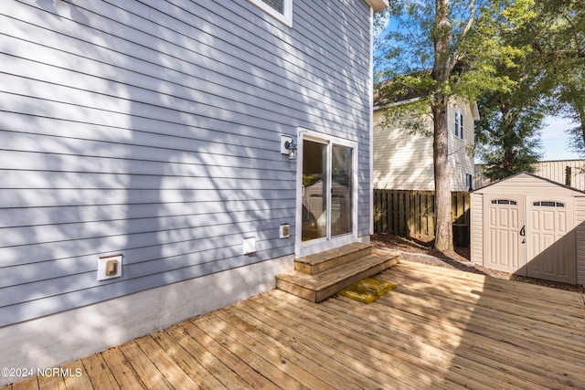 wooden terrace with a storage shed