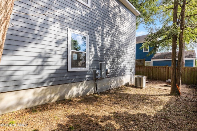 view of side of property with central AC unit