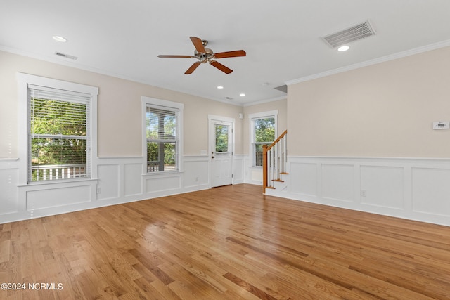 unfurnished room featuring light wood-type flooring, ceiling fan, and crown molding