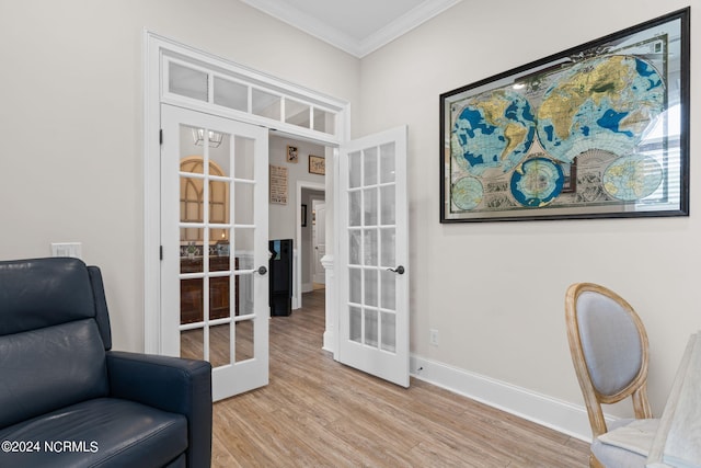 living area with french doors, ornamental molding, and light hardwood / wood-style floors