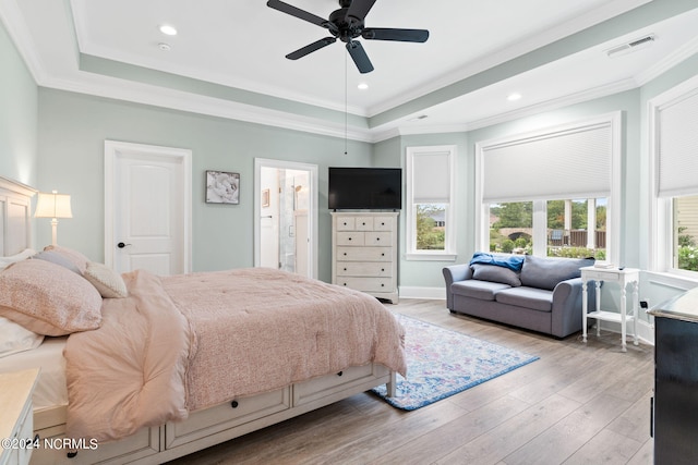 bedroom with ceiling fan, light wood-type flooring, ensuite bath, and crown molding