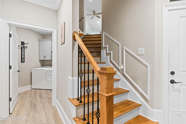 stairs with washer and clothes dryer, ceiling fan, and hardwood / wood-style flooring