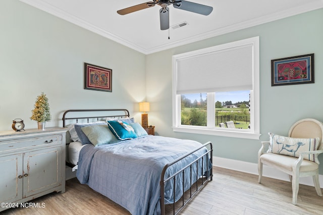 bedroom with light wood-type flooring, ornamental molding, and ceiling fan