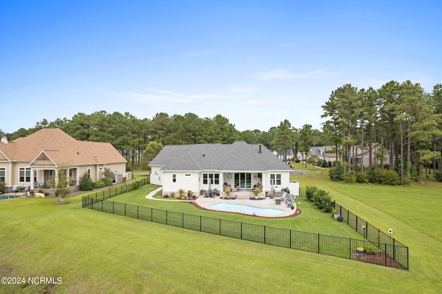 back of property with a lawn and a patio