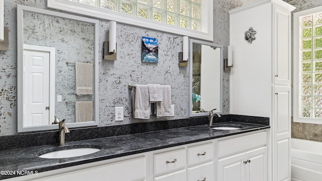 bathroom with a bathing tub and vanity