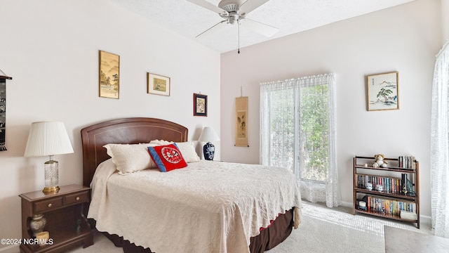 bedroom with a textured ceiling, light carpet, and ceiling fan