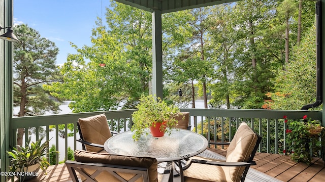 wooden terrace featuring a water view