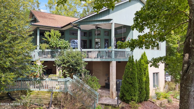 rear view of property with central AC unit and ceiling fan