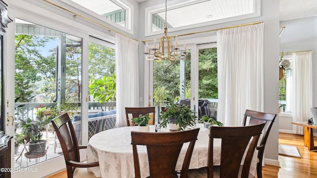 dining room featuring light hardwood / wood-style floors and a chandelier