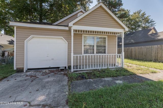 view of front of home featuring covered porch and a garage