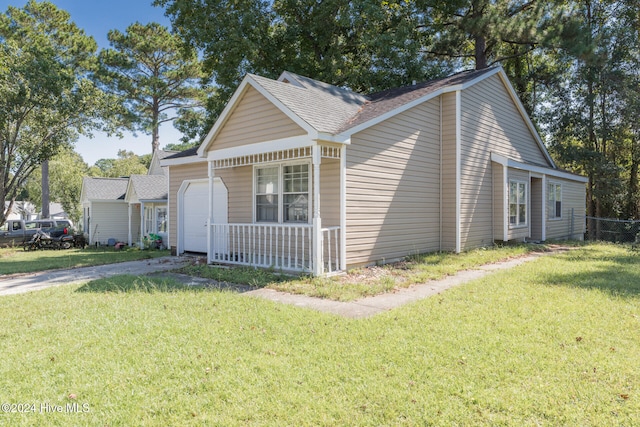 view of front of home featuring a garage, a porch, and a front yard