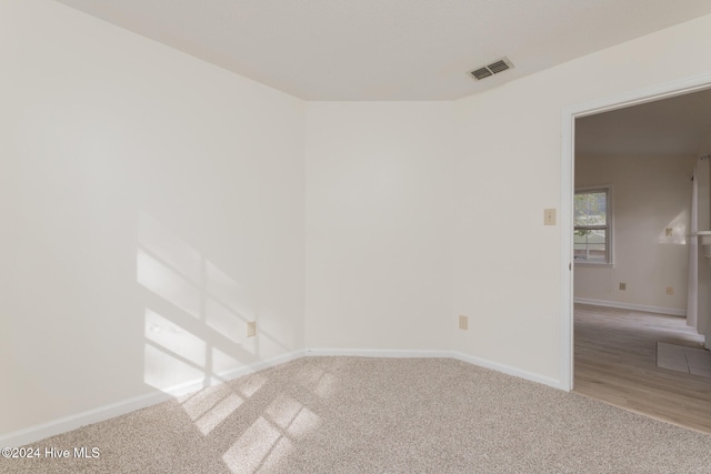 unfurnished room with wood-type flooring