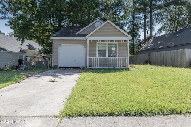 view of front facade featuring a garage, covered porch, and a front yard