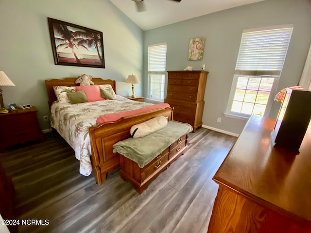 bedroom with vaulted ceiling, dark hardwood / wood-style flooring, and ceiling fan