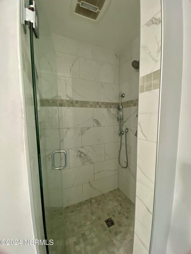 bathroom featuring an enclosed shower