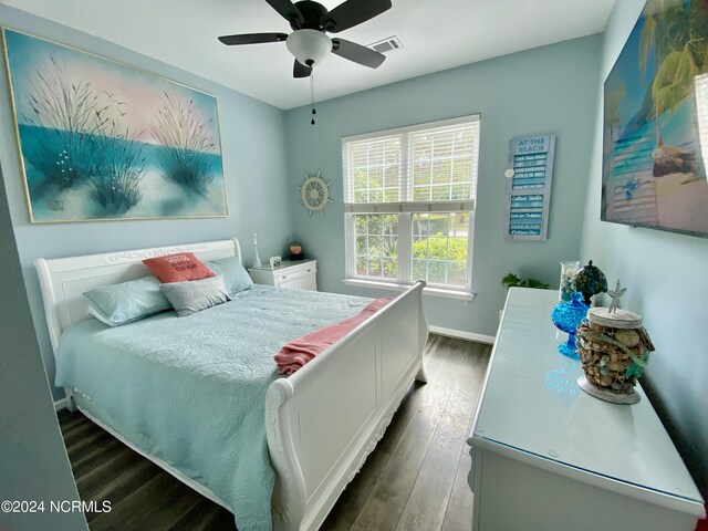 bathroom featuring vanity, walk in shower, toilet, wooden walls, and hardwood / wood-style floors