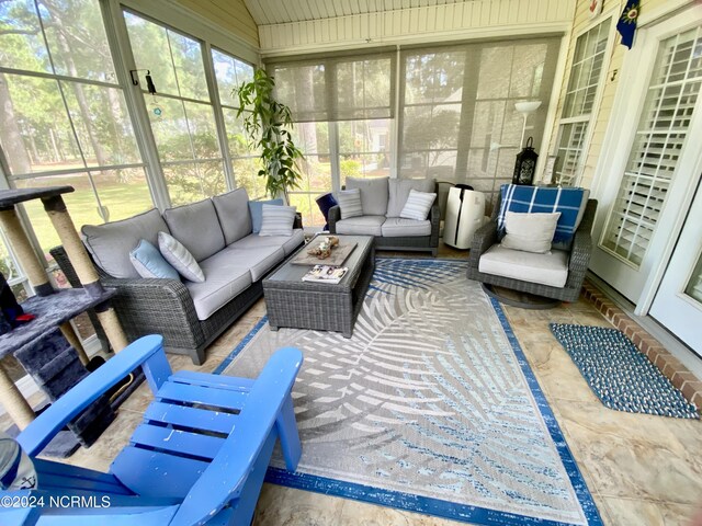 sunroom / solarium featuring lofted ceiling