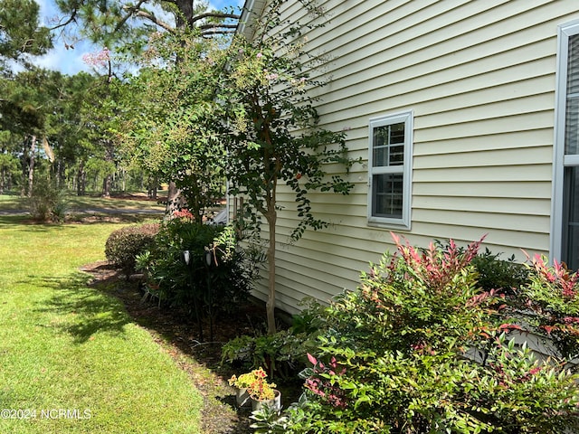 view of side of property with a lawn