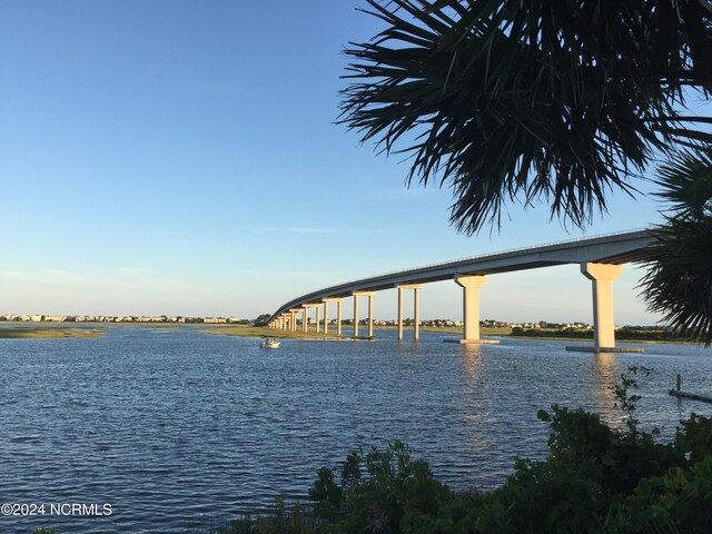 view of property's community with a water view and a yard