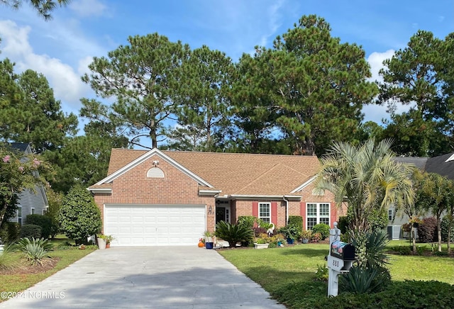 single story home featuring a garage and a front lawn