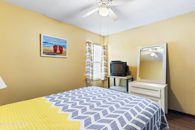 200 Lake Park Blvd S Unit 7A, Carolina Beach, NC 28428 - bedroom featuring a textured ceiling, wood finished floors, and a ceiling fan