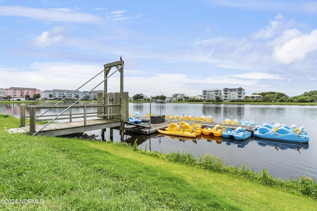 view of dock featuring a water view and a yard