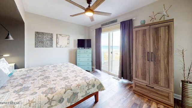 bedroom featuring access to outside, ceiling fan, and dark wood-type flooring