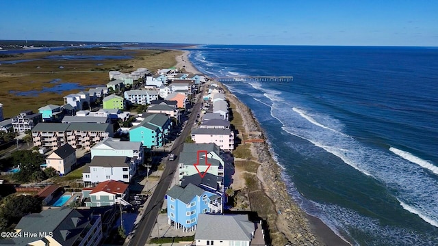 drone / aerial view with a water view and a beach view