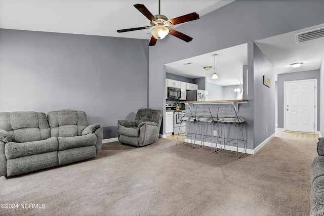 carpeted living room featuring ceiling fan