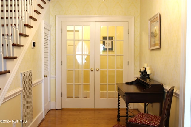 doorway with french doors and hardwood / wood-style flooring