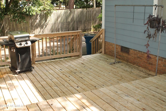 wooden deck with a grill