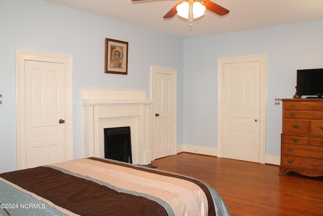 bedroom with ceiling fan and dark wood-type flooring