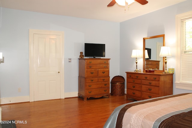 bedroom with ceiling fan and hardwood / wood-style flooring