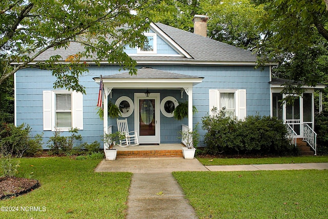 view of front of house with a porch and a front yard