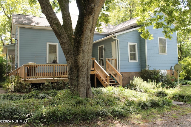 rear view of property with a deck