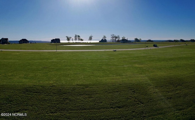 surrounding community featuring a yard and a rural view