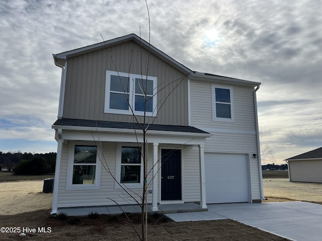 view of front of house with central AC and a garage